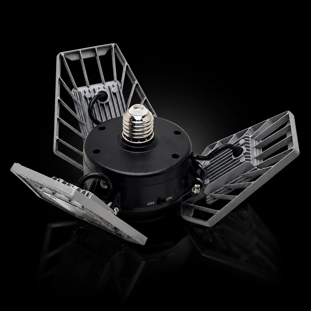 A 360-degree rotating LED floodlight with three wings, featuring a black central body, silver metal wings, and a threaded screw-in socket on a white background.