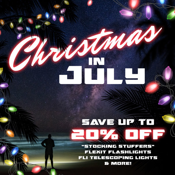 Christmas in July home page banner. Save up to 20% off. "stocking stuffers" flexit flashlights, Fli telescoping lights, & More! Festive image of a person's silhouette at the beach at night.